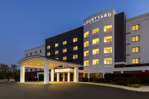 Courtyard by Marriott hotel exterior at dusk with illuminated entrance.