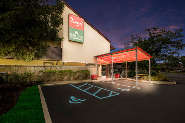 Red Roof Inn exterior at dusk with covered entrance and parking lot.