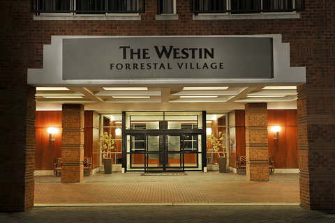 Grand entrance to The Westin Forrestal Village hotel with modern facade and warm lighting.