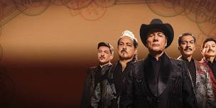 Mariachi musicians in traditional attire posing for a portrait against a warm, sepia background.